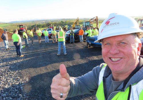 Barry Schlouch thumbs up with crew in the background