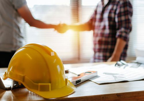 Construction helmet on a desk with papers