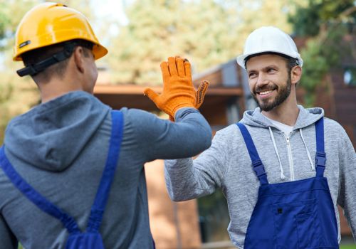 Guys in constrution gear high fiving