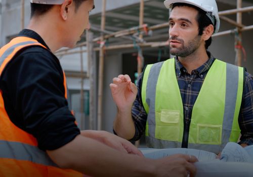 Construction workers going over a blueprint for a building