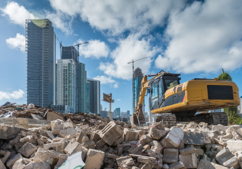 Heavy machinery cleaning a rubble site for a new housing development site in Miami.