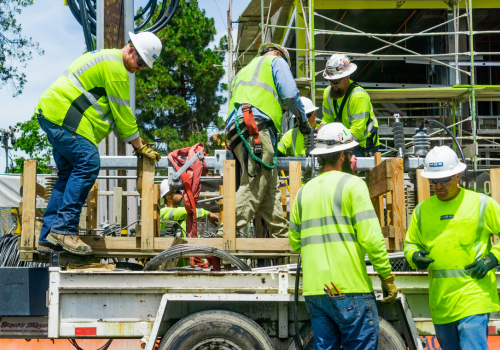 June 24, 2019 Mountain View / CA / USA - Team of construction workers wearing bright yellow vests and hard hats